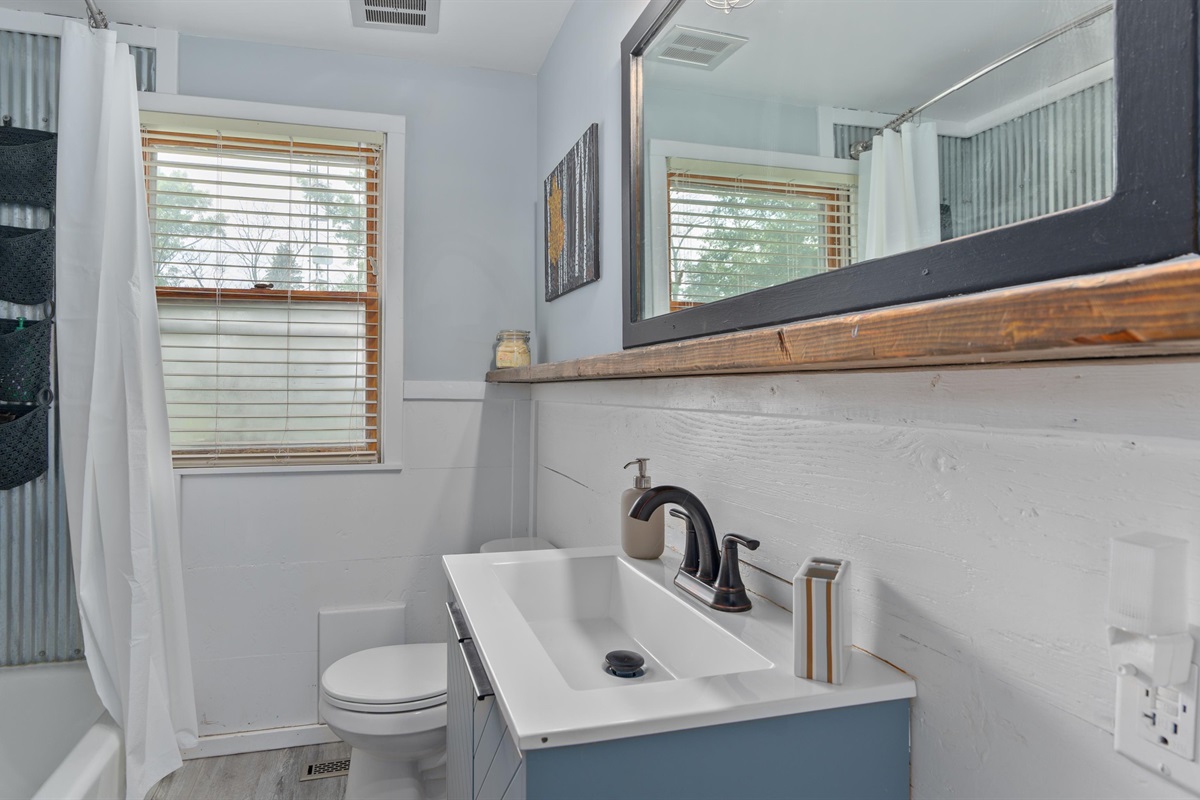 Upstairs full bathroom with fun sheet-metal tub surround!