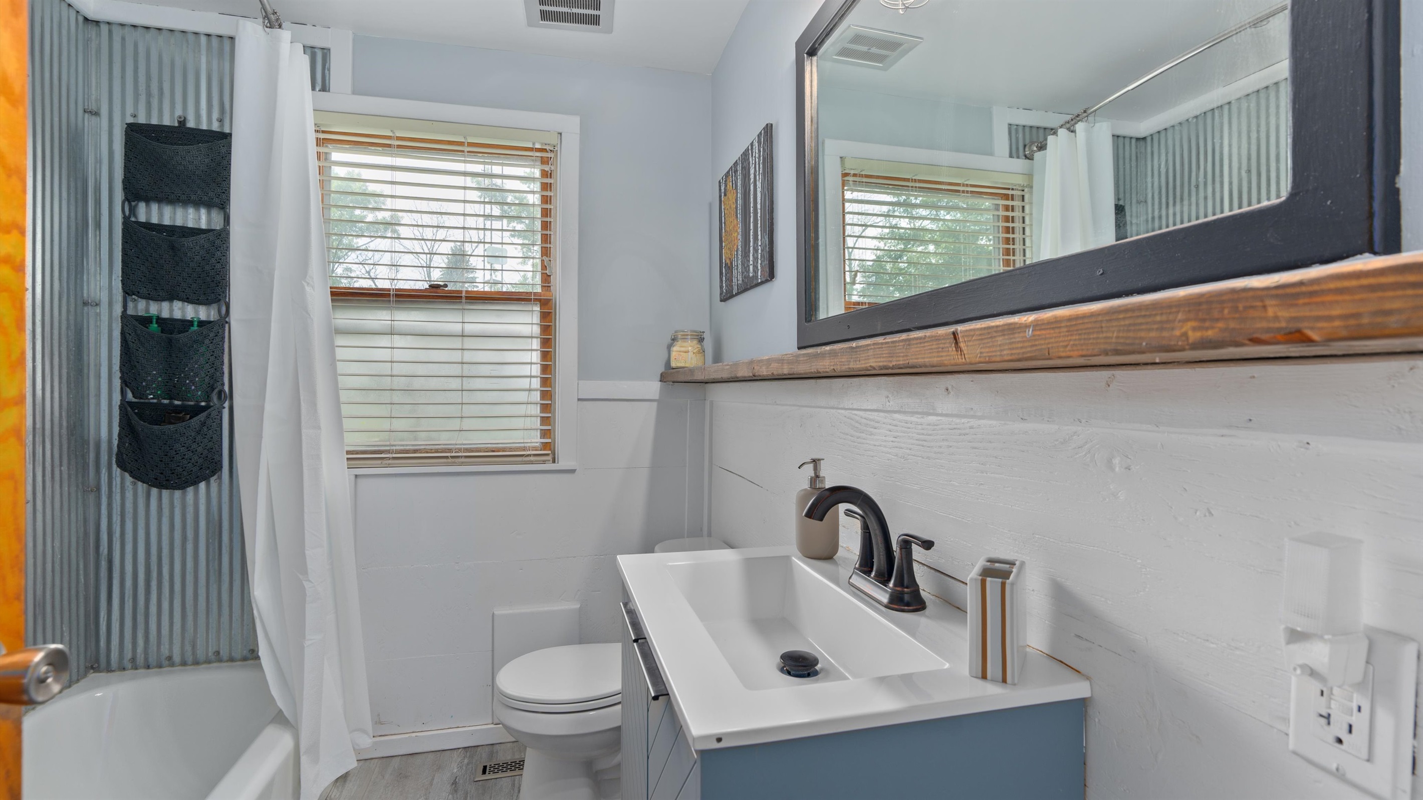 Upstairs full bathroom with fun sheet-metal tub surround!