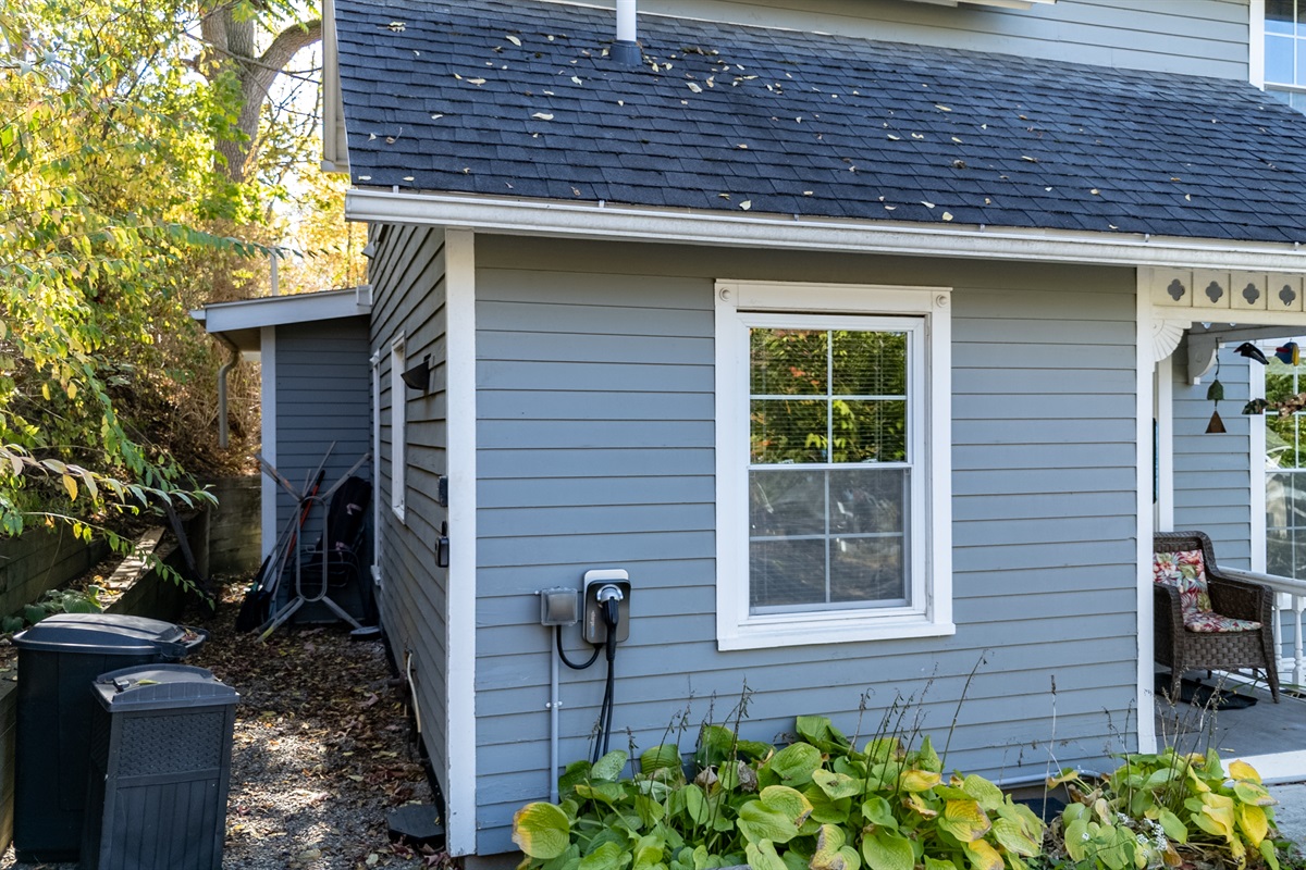 Beautiful side view featuring fresh blue siding and bright windows that fill the home with natural light