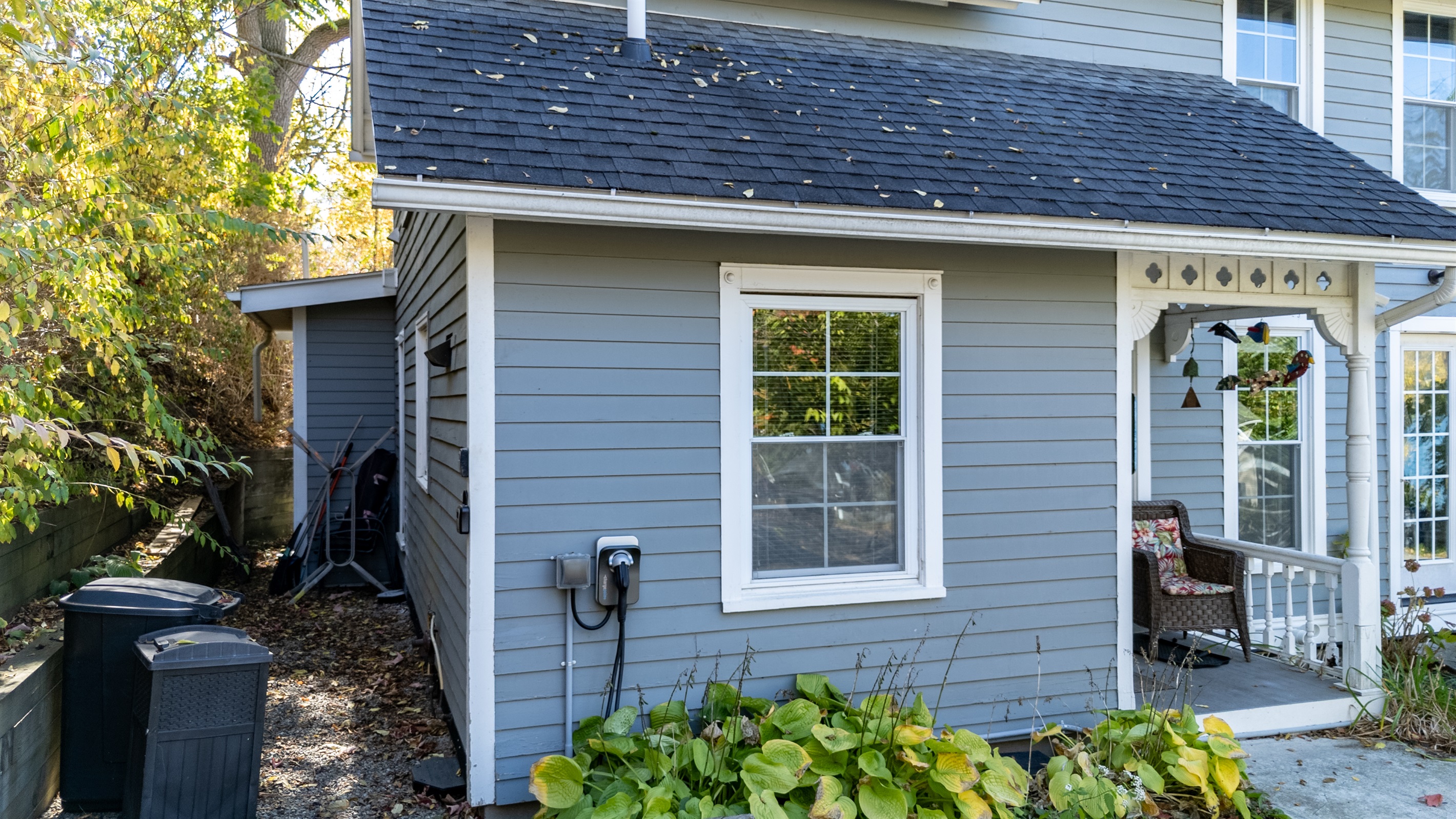 Beautiful side view featuring fresh blue siding and bright windows that fill the home with natural light