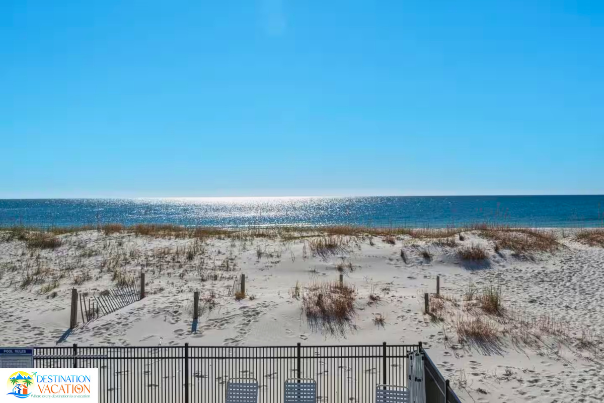 Golden dunes meet sparkling blue waters.