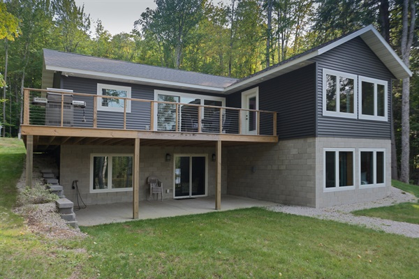 Two-level lake home with main deck + lower walk-out patio.”