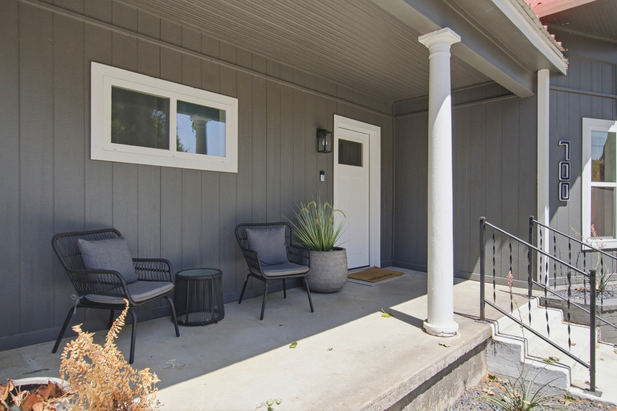 Relax on chic chairs and soak up the Texas sun on this stylish porch!