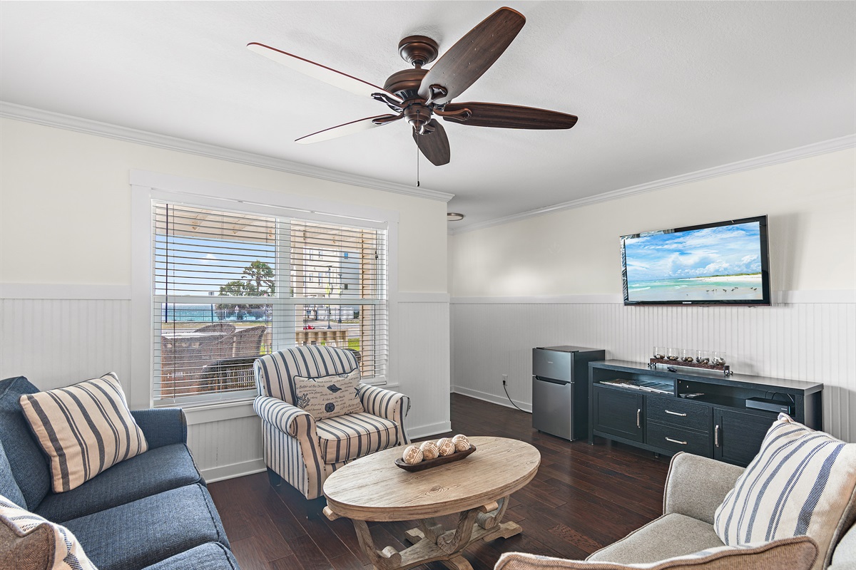 Gulf View Living Space - Plenty of Comfortable Seating in the Living Room situated around a large Smart TV + Access to the Front Covered Patio overlooking the Gulf of Mexico!