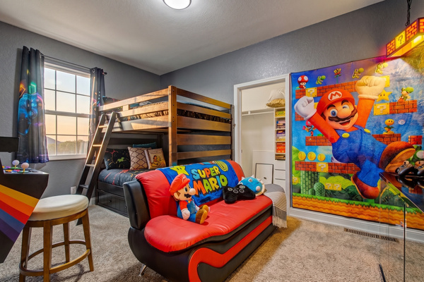 Game room bedroom with full-over-full bunk beds, twin trundle, Super Mario lounge and smart TV