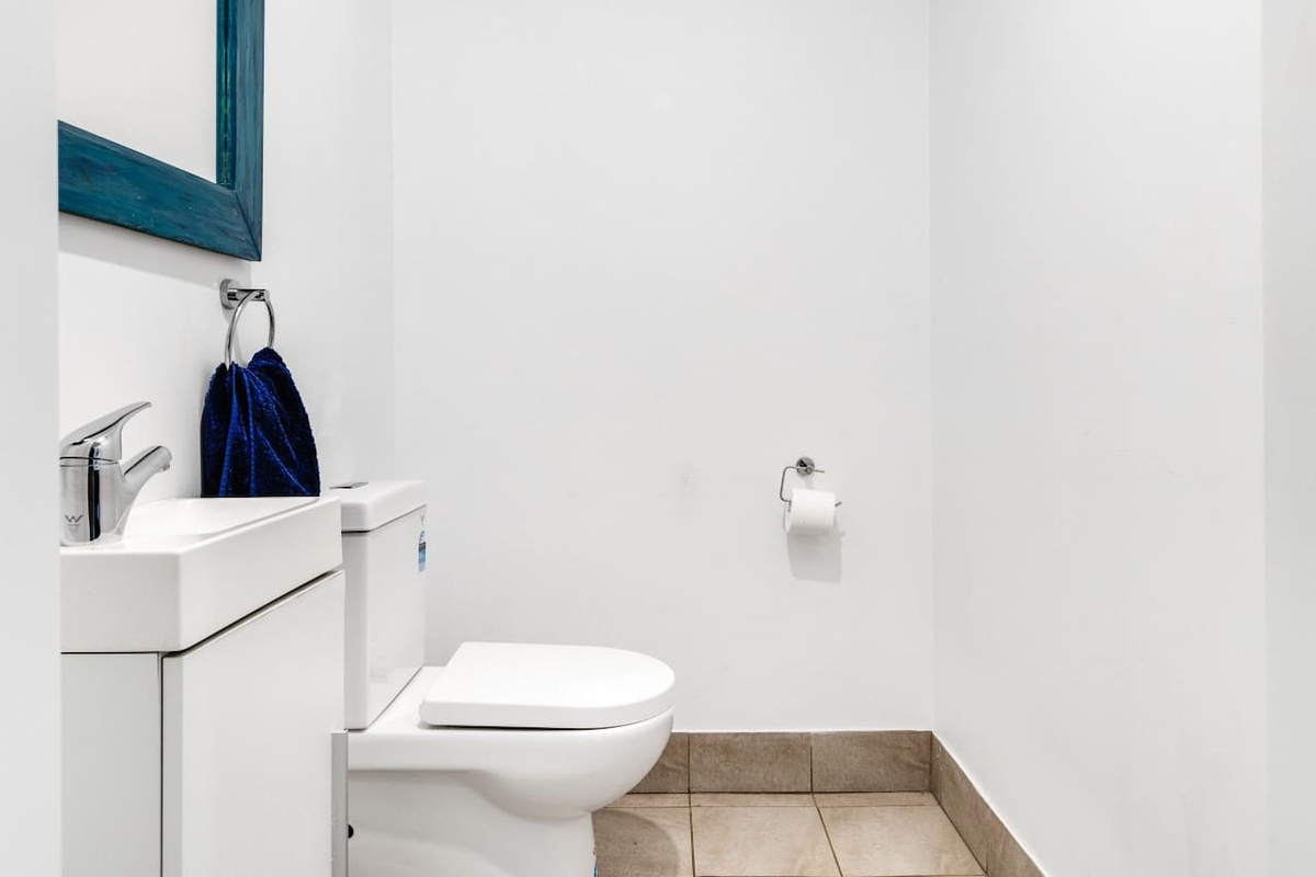 This upstairs second bathroom gives the upper level an additional toilet space near the bedrooms and main living areas.