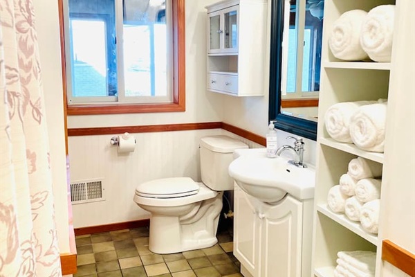 Full bathroom with bathtub and essentials for a comfortable stay.