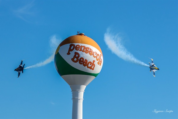 Two Blue Angels practicing airshow routines over Pensacola Beach