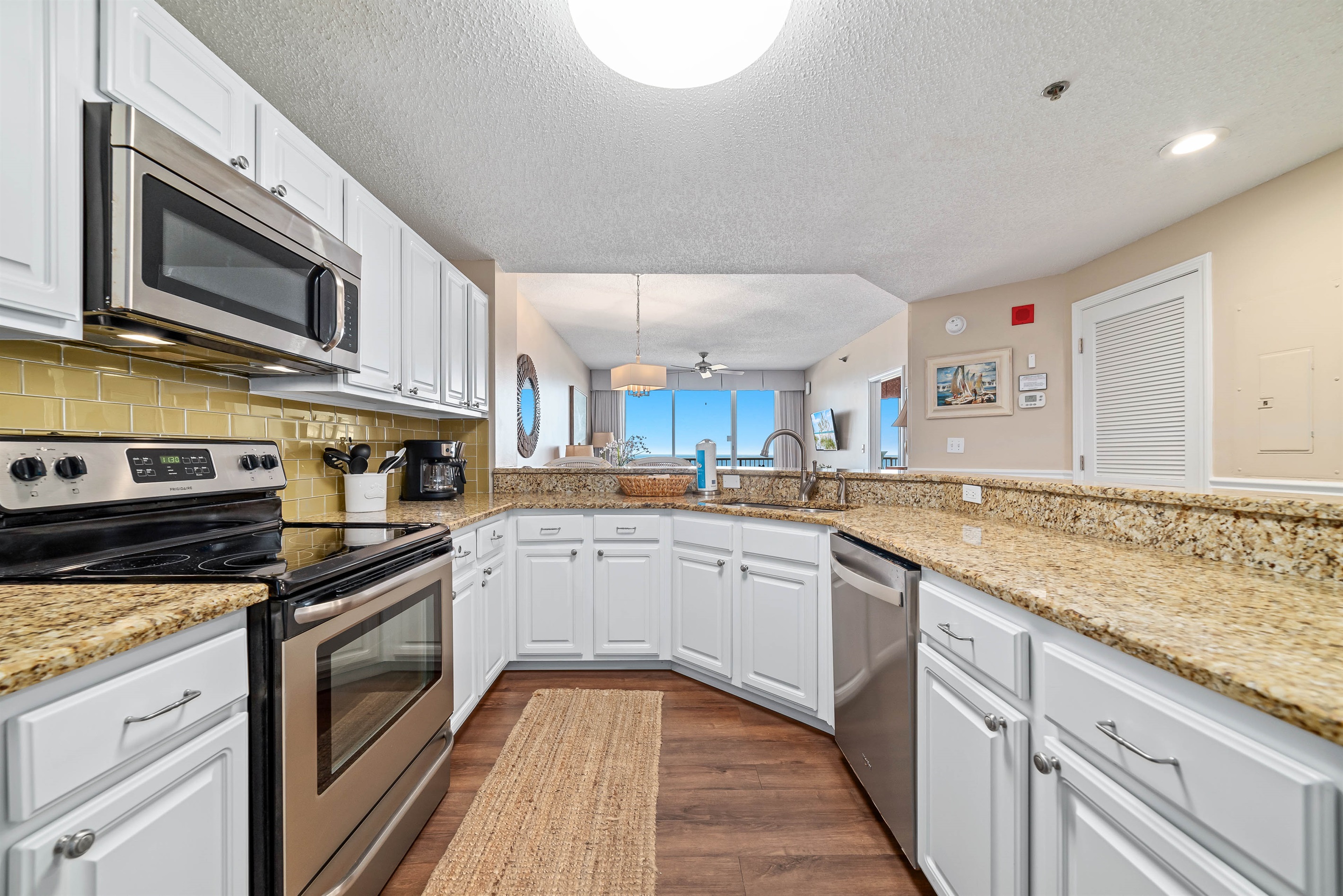 A tidy and functional kitchen countertop. This organized space, complete with coffee makers, a toaster, and a paper towel holder, makes everyday tasks a breeze.