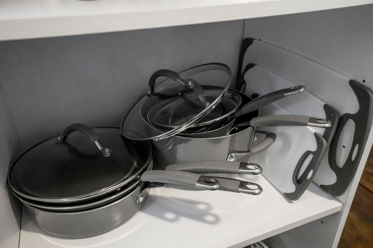 Close-up view of pots, pans, and cutting boards, offering all the kitchen essentials for meal preparation."