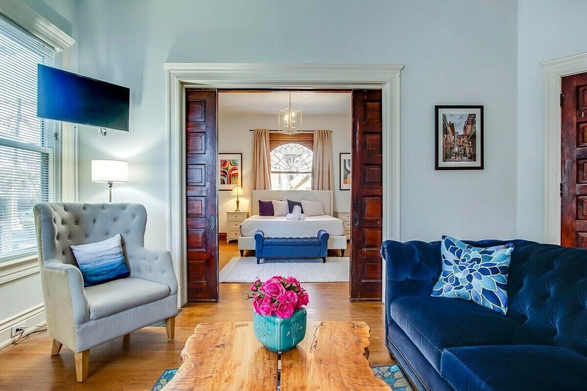 Massive first floor King Suite with Fireplace, blackout curtains, and grand pocket doors that open to the living room. 