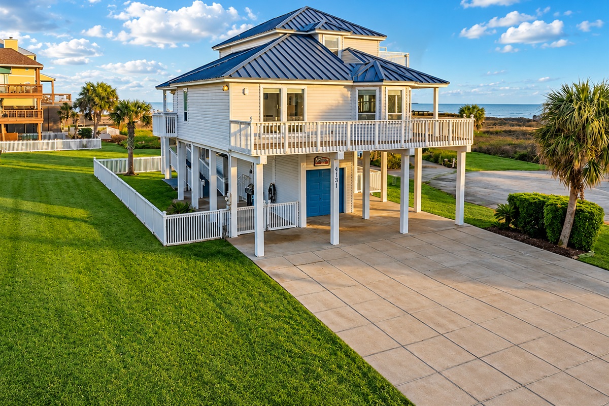 Quintessential beach house with a picturesque escape, capturing the essence of coastal charm from its pristine white picket fence and coastal blue tin roof to its soothing nautical interiors.