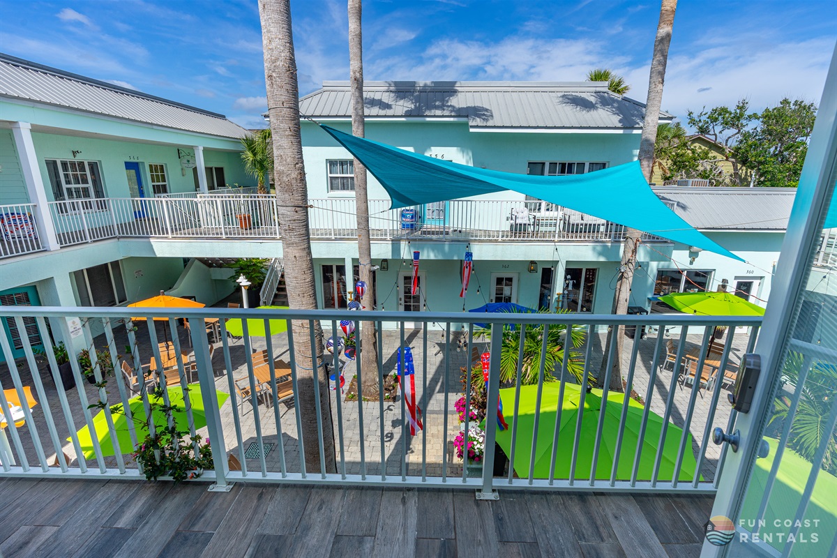 Quaint balcony overlooking community courtyard with shops and restaurants!