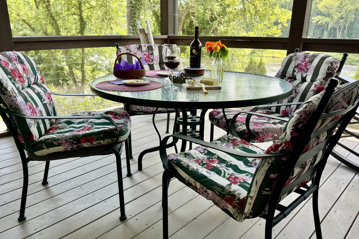 Screened-in dining porch with scenic river views