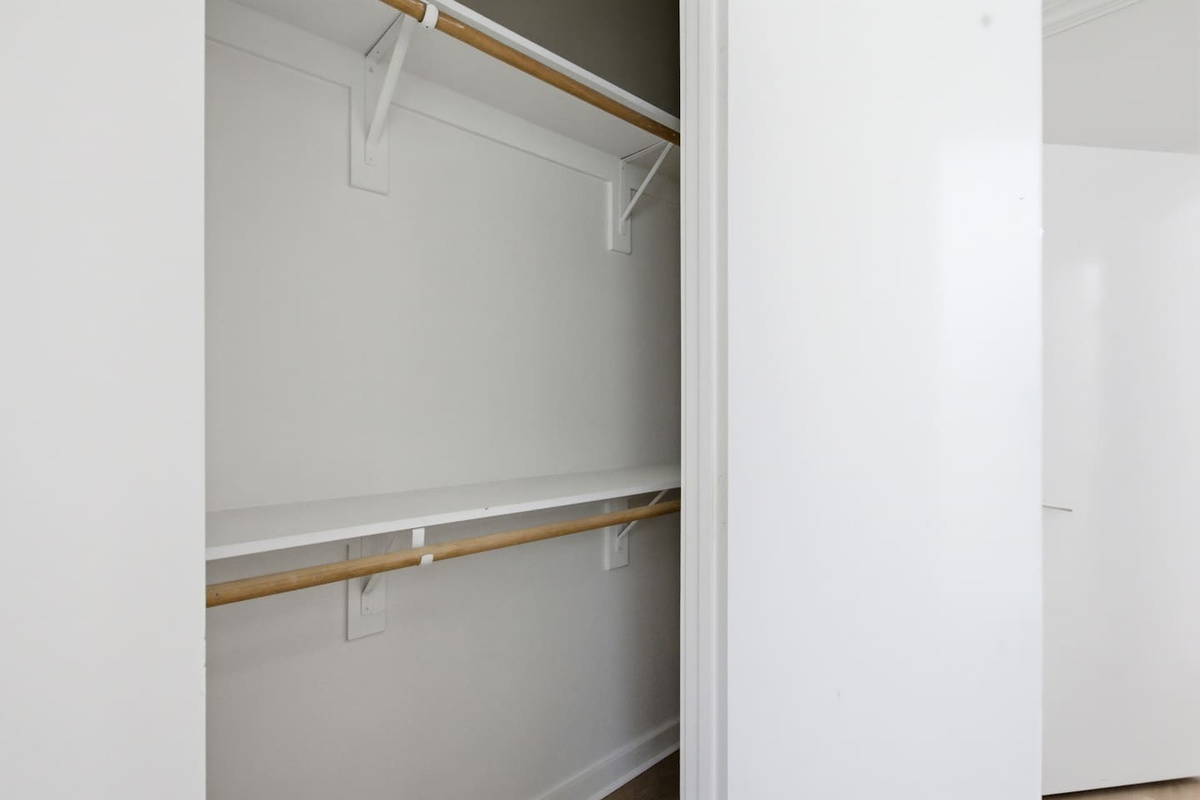 First-floor bedroom closet with open shelving and hanging space. Easy to access and organized for guests on the lower level who want their own dedicated storage area.

