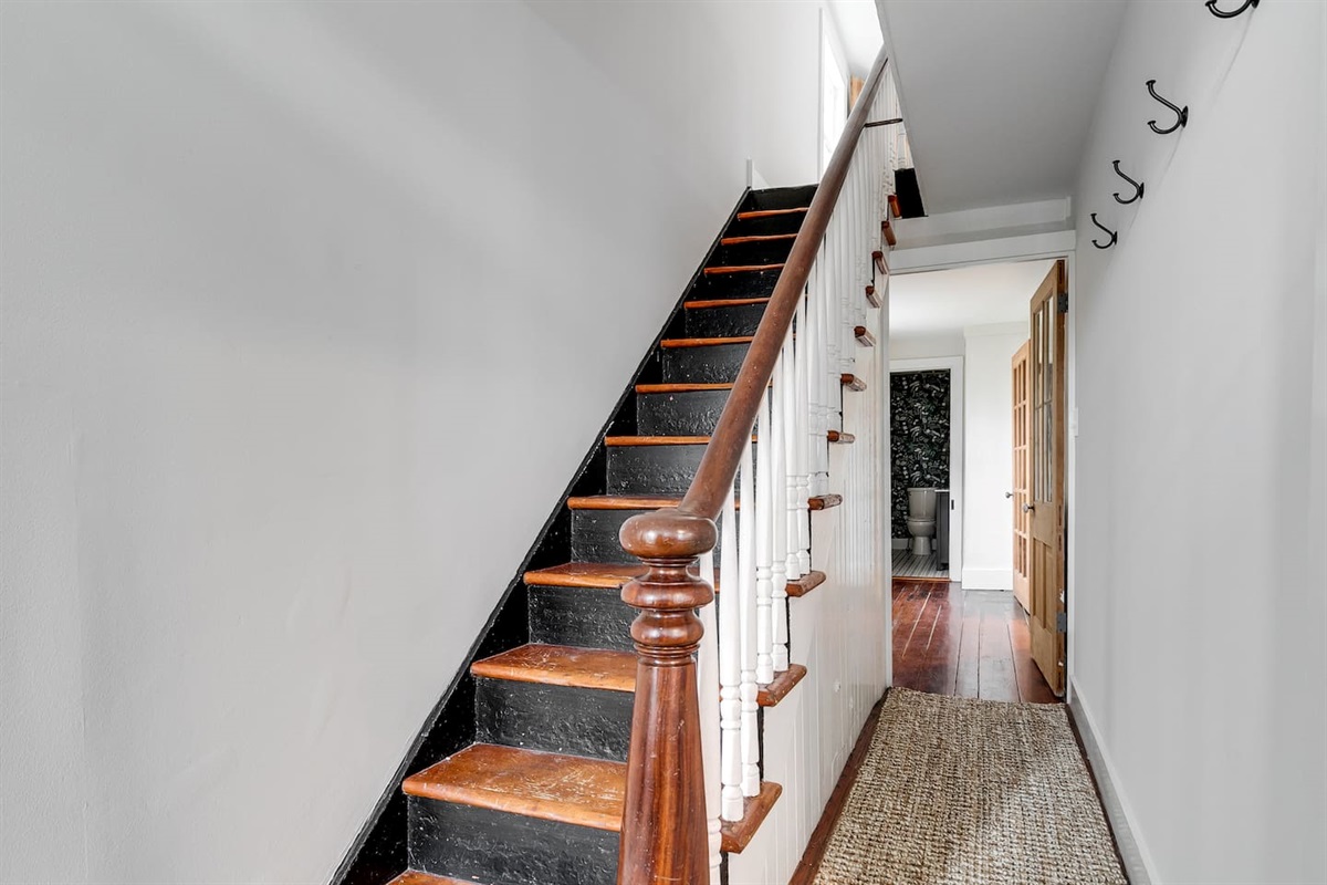 Entry Hallway: Charming staircase leads you to hidden treasures of Richmond!