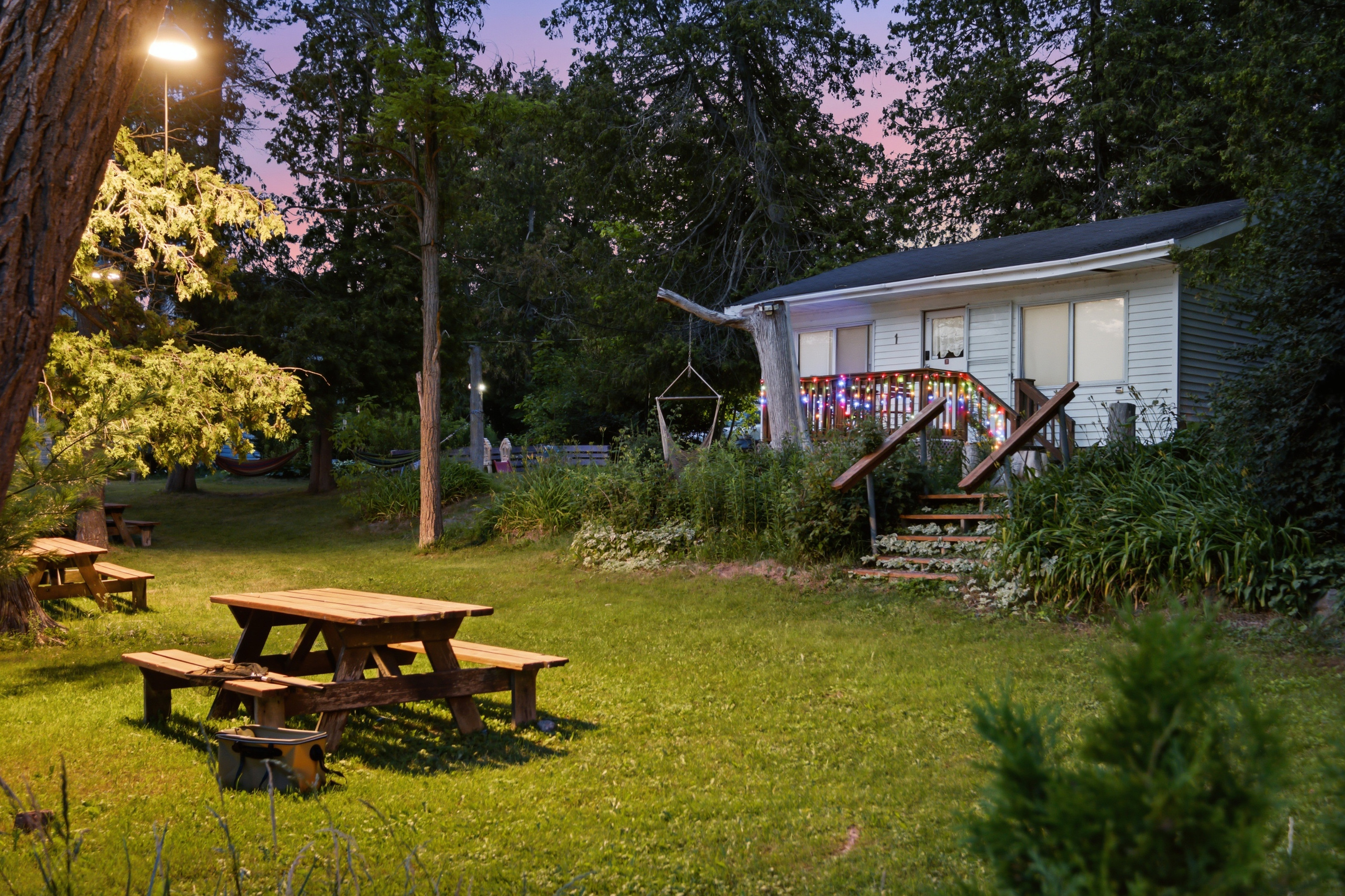 Cottage #1 exterior with picnic area and spacious green lawn