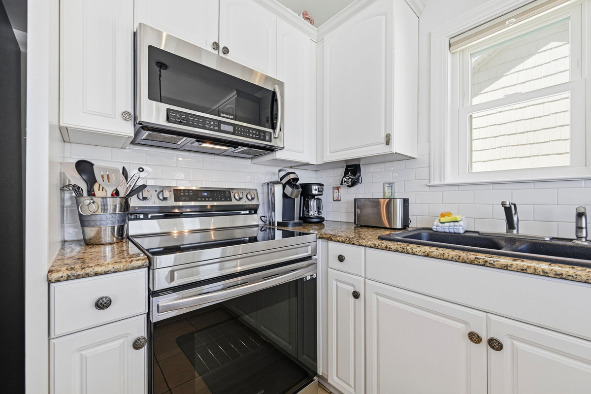 Clean coastal kitchen with high-end finishes and everything ready for effortless meals after a beach day