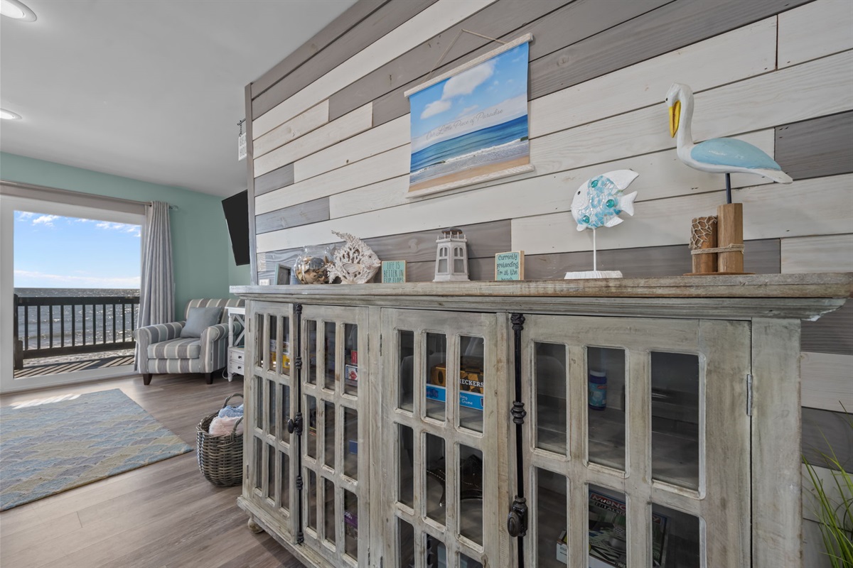 This stylish console and feature wall add character and a relaxed coastal vibe, perfectly complementing the open living space and oceanfront setting