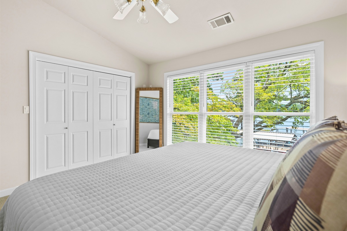 A calm and airy guest room with fresh linens and plenty of closet space.