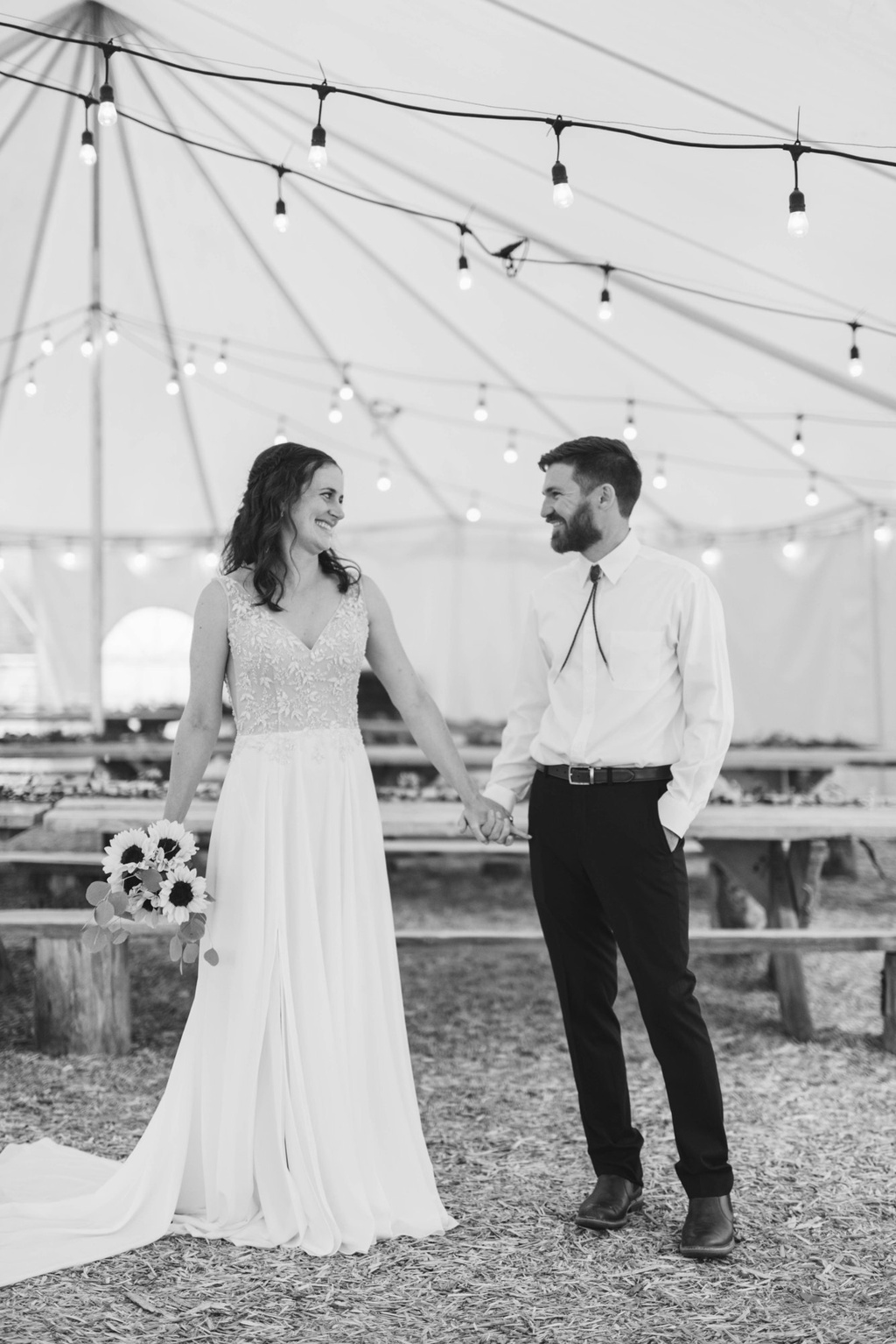Bride and groom under the tent lights