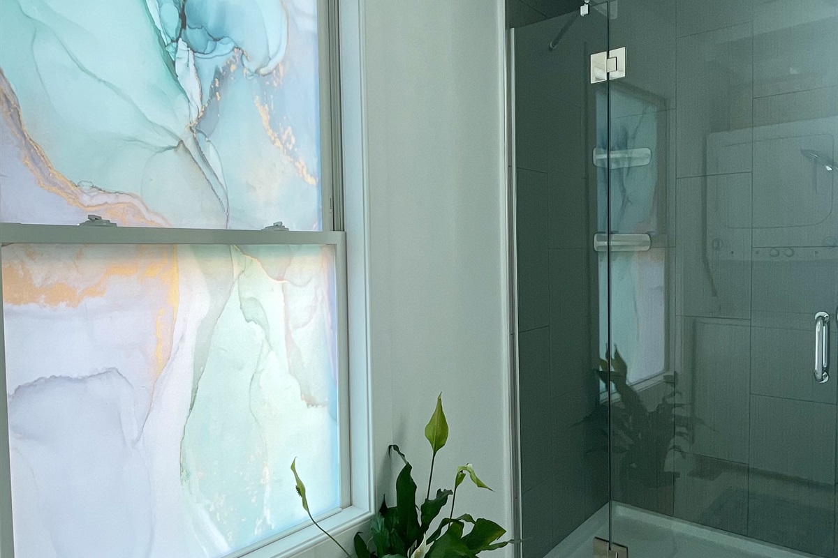 The second bathroom features a multi directional shower and a heated tile floor!