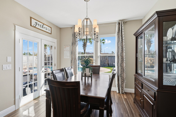 Coastal dining room with natural light and comfortable seating for family gatherings.