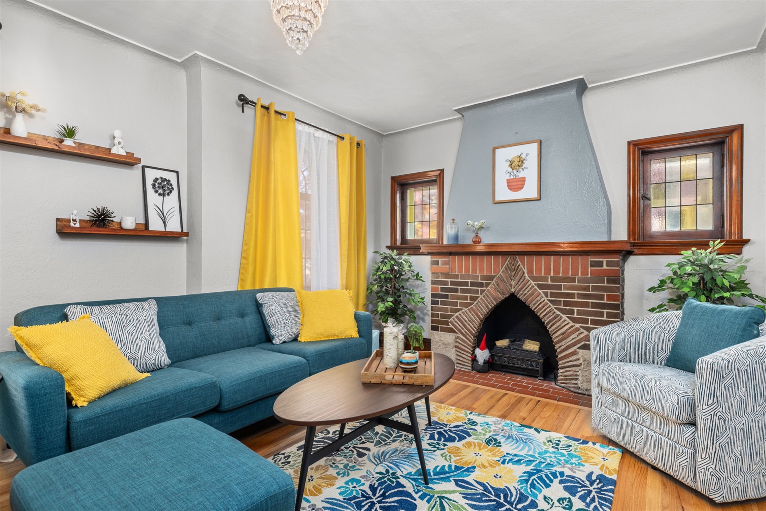 Main level living area with ample seating for 6+ and artificial fireplace.