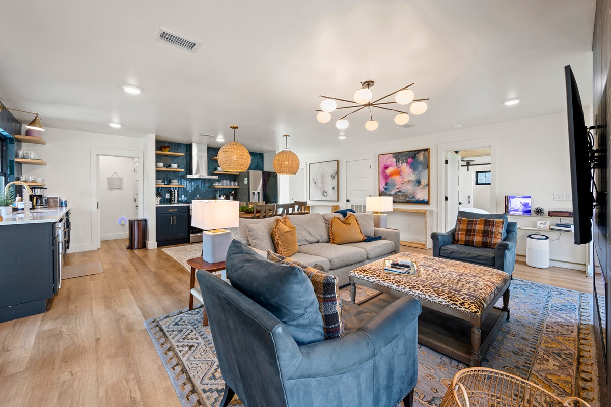 The open flow between the living room and kitchen makes it easy to keep conversations going, creating a seamless space for gathering, cooking, and relaxing all at once.