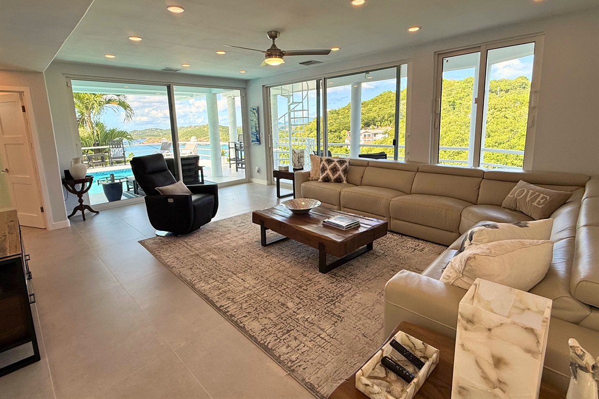 This spacious living room leads to the pool deck