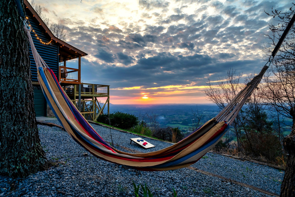 Gently sway in the hammock as the Smoky Mountains stretch out before you, glowing beneath a breathtaking sunset. Golden hour feels a little different up here - peaceful, unhurried, and meant for slowing down.