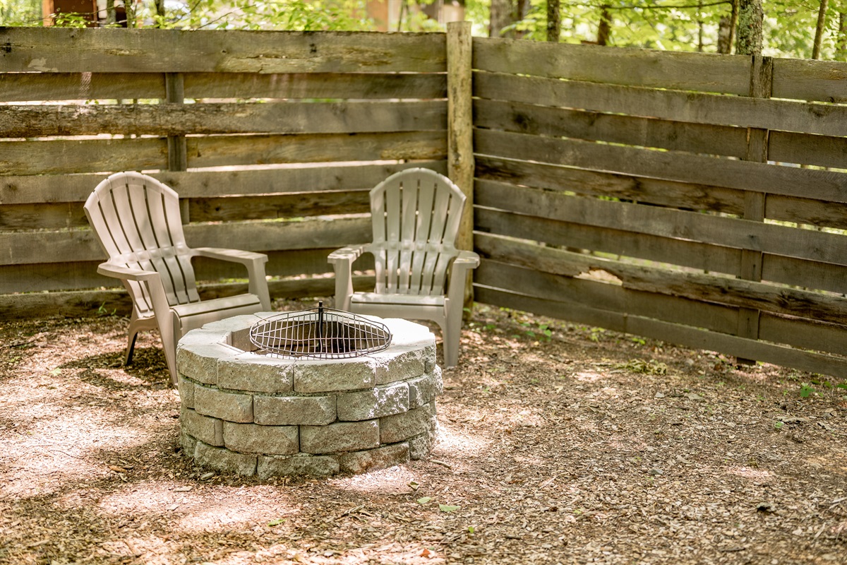 Lounge area with fire pit outside of the tent. 