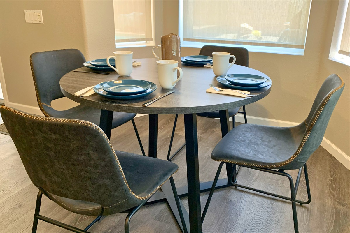 Sunlit dining area with seating for four, perfect for shared meals or morning coffee.