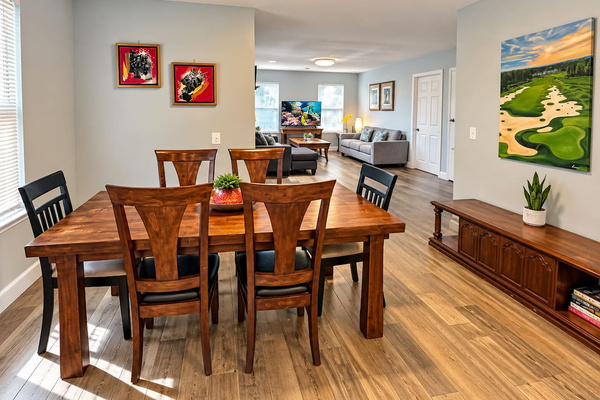 Dining Room: Enjoy meals with style at this spacious wood table, bathed in natural light!