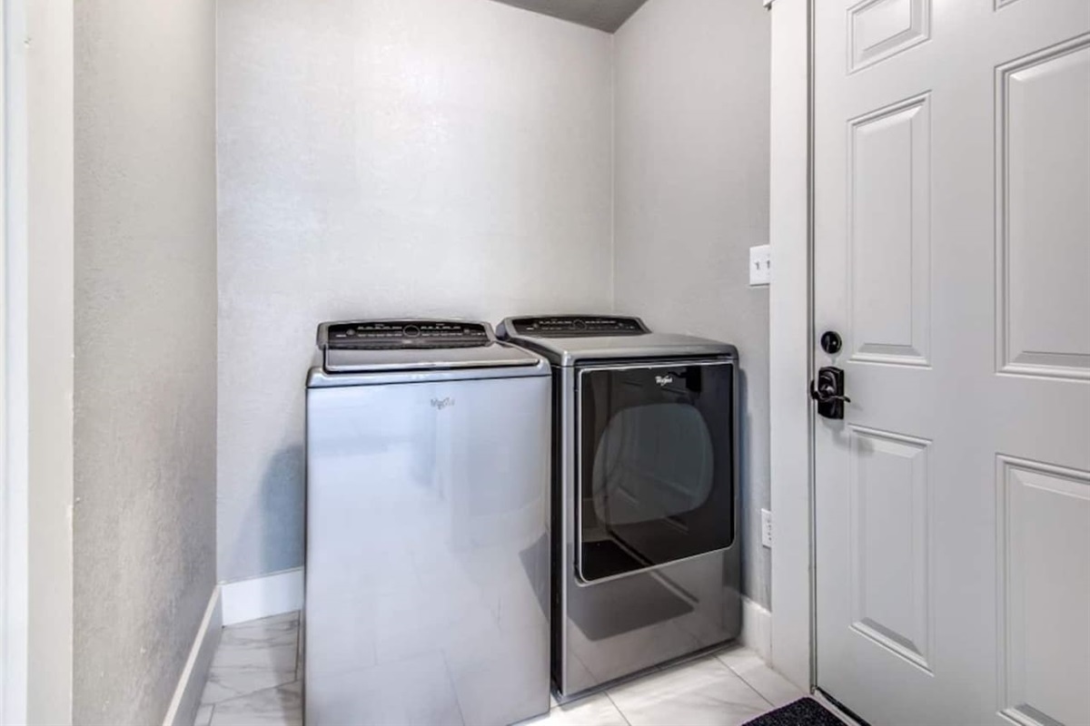 In-unit full-size washer and dryer plus iron, hangers, and drying rack. Rare convenience for short-term rentals in Aubrey TX. Ideal for extended stays and multi-night wedding weekends near Lake Ray Roberts and Denton County.