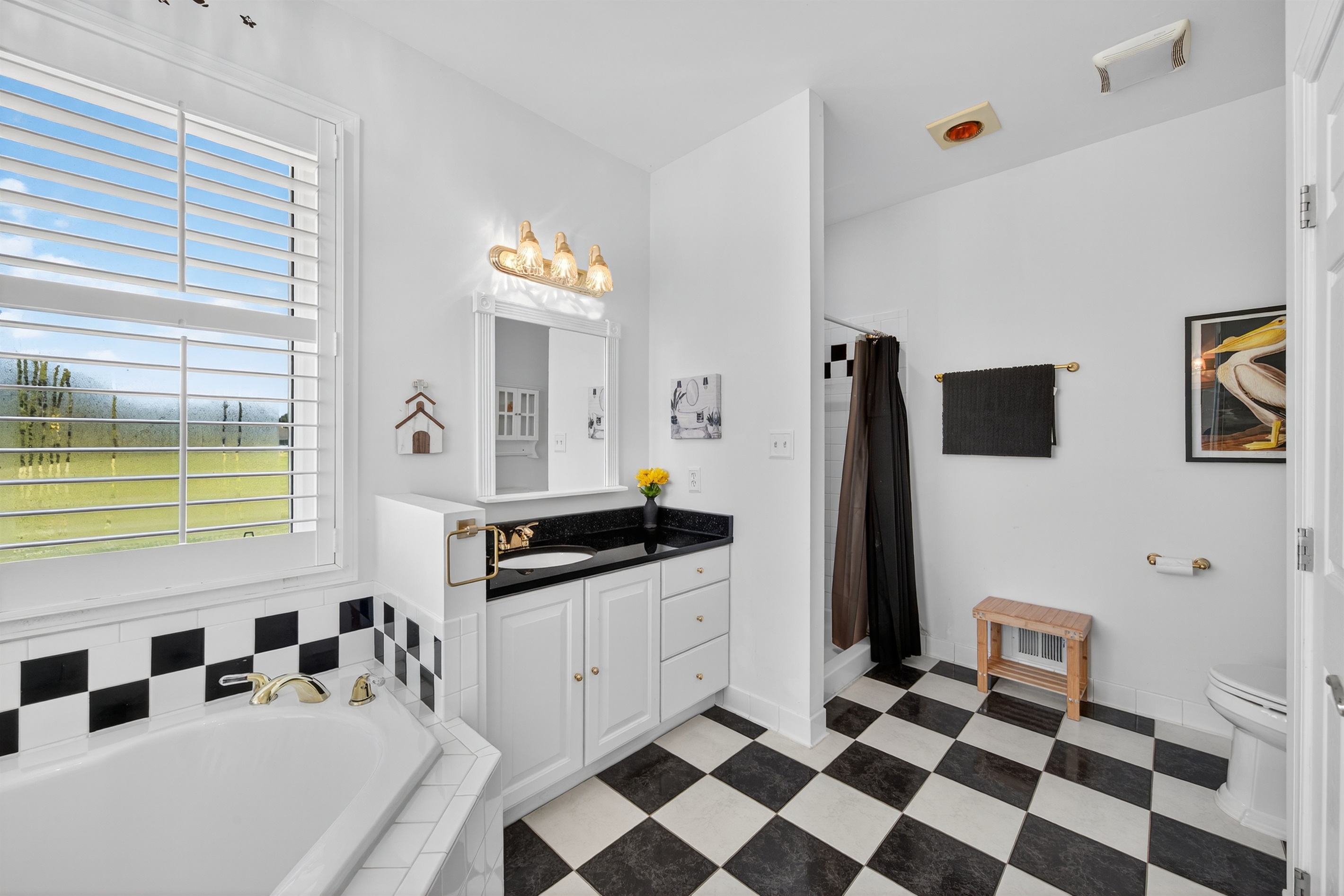 Spacious bathroom with walk-in shower and soaking tub.
