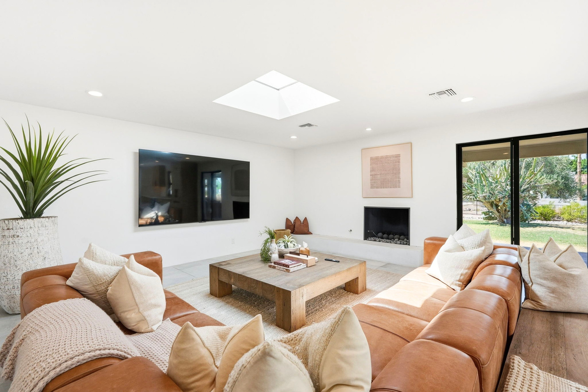 Enjoy sitting by the fire and watching the 98" TV in the family room