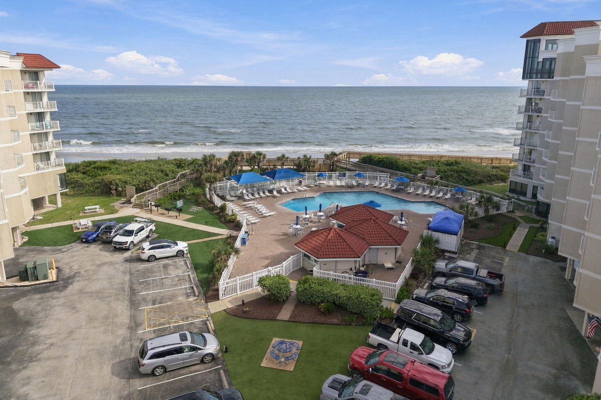 Elevated aerial view of the resort property, pool area, and coastline.