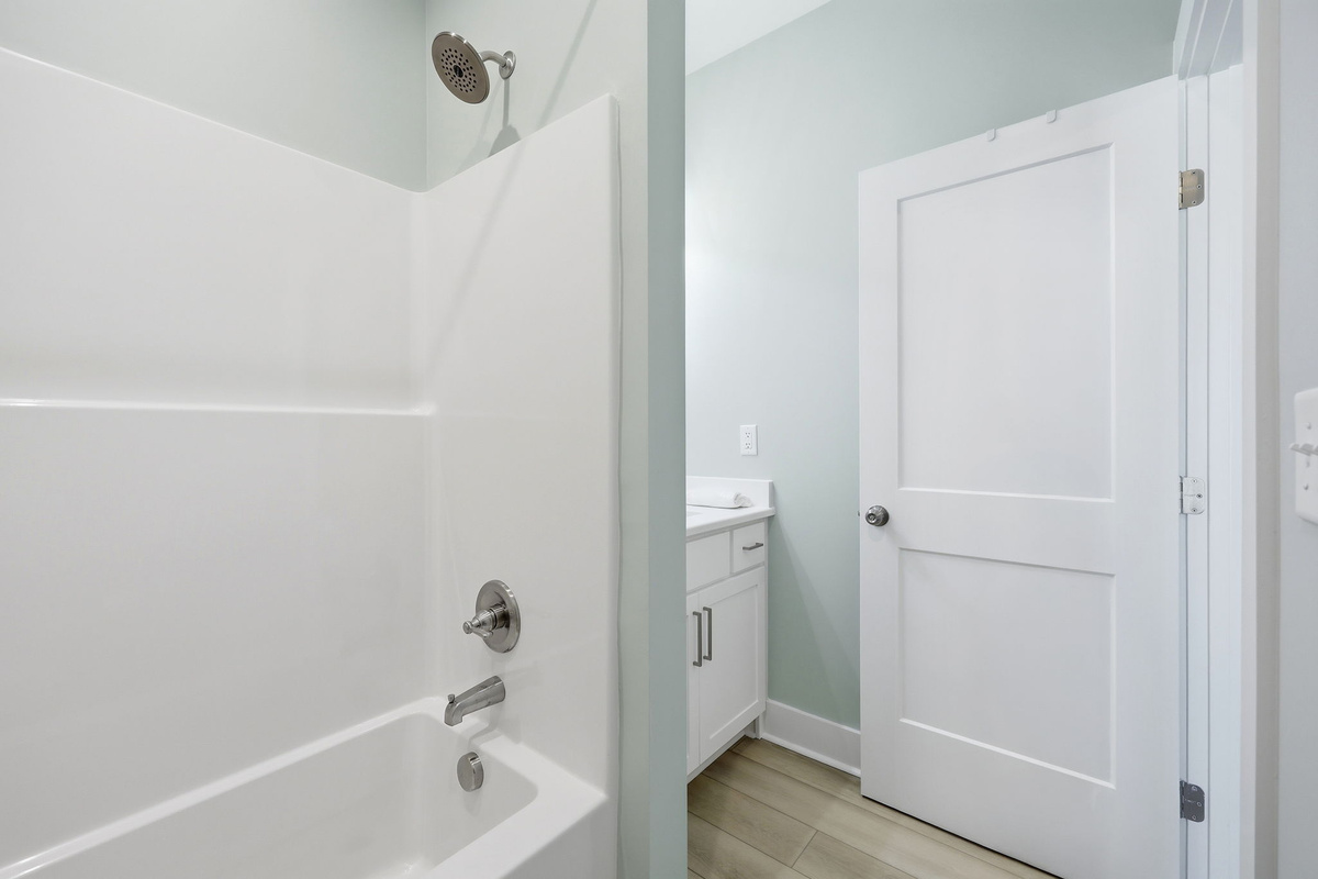 This bright, modern bathroom provides direct access from the queen bedroom for added comfort and privacy