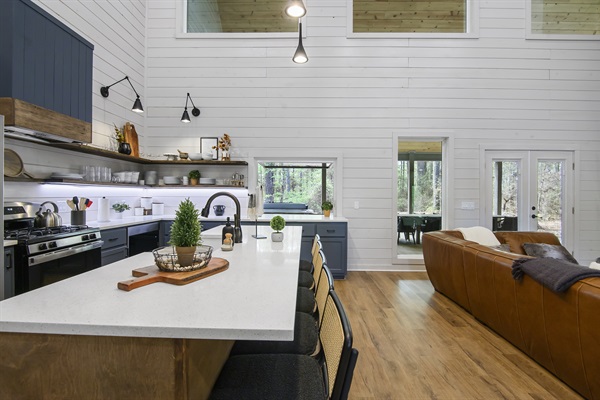 Fully stocked kitchen overlooks the living area and large TV.