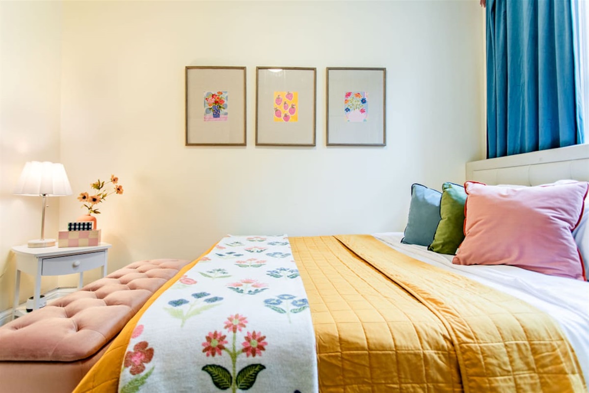Comfortable queen-sized bedroom offering a restful retreat with ample space and natural light.