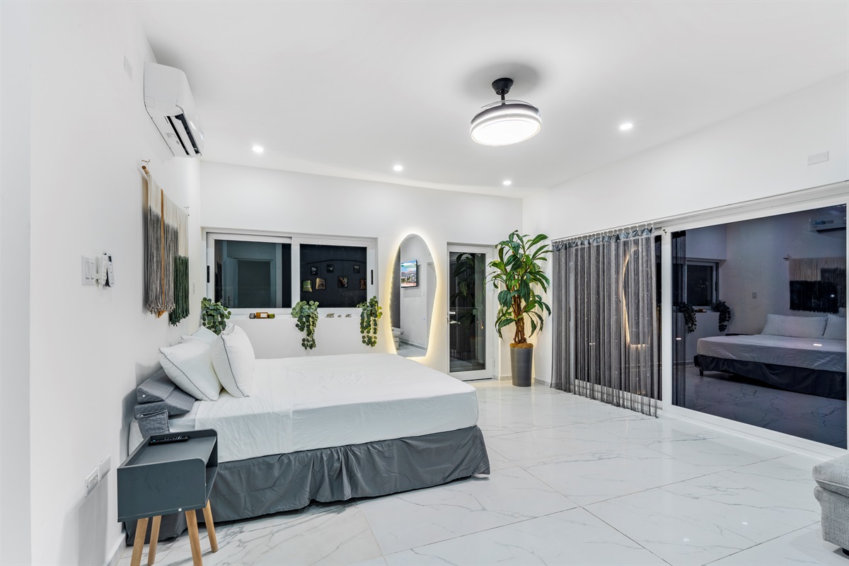 Spacious king suite with LED-lit mirror and sliding doors