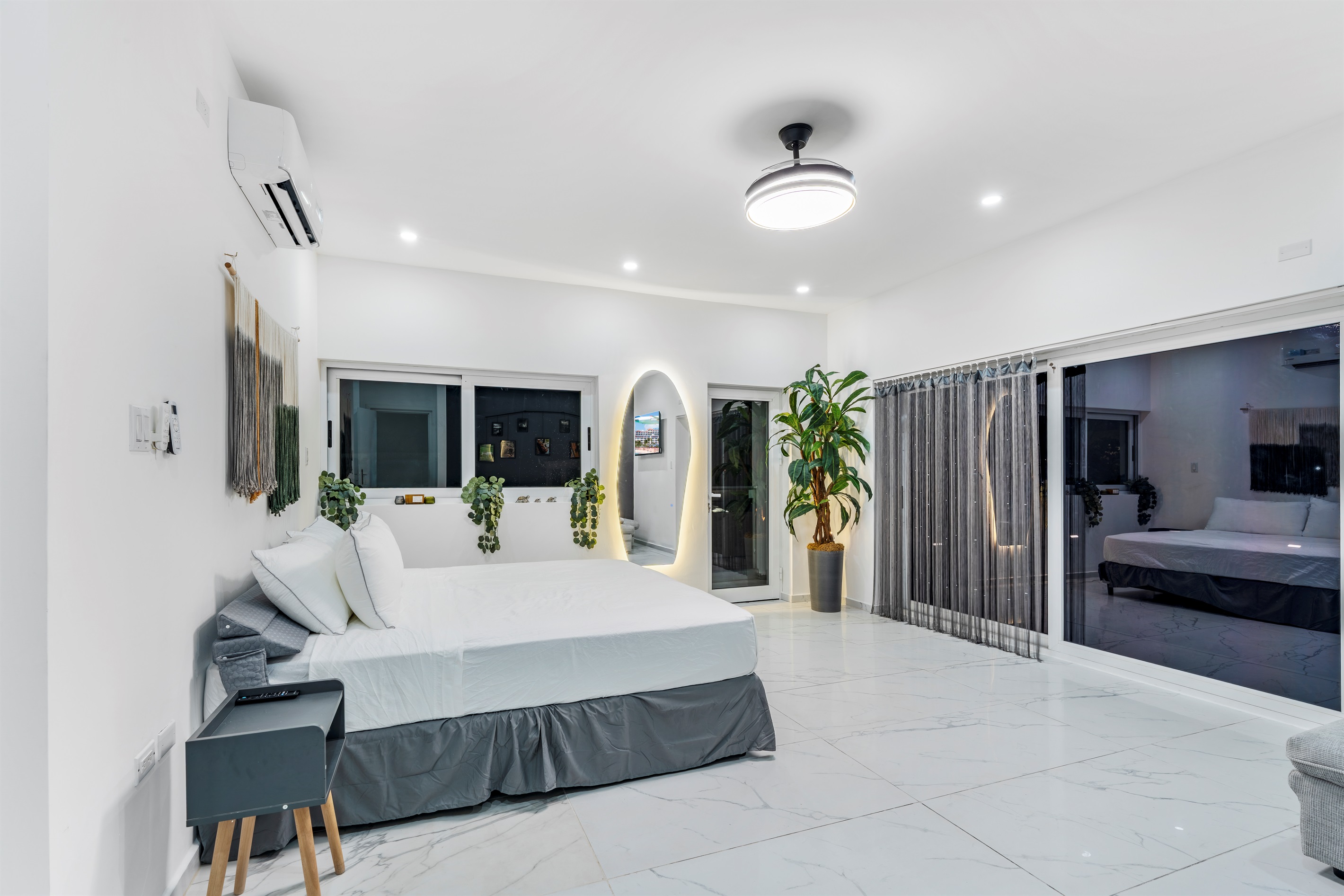 Spacious king suite with LED-lit mirror and sliding doors