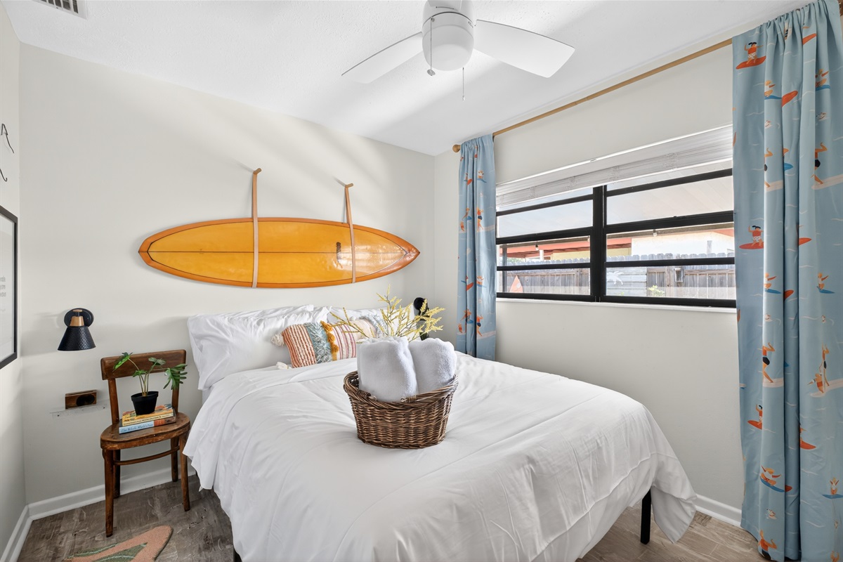 Surf Bedroom: Queen DreamCloud Hybrid bed with blackout curtains.