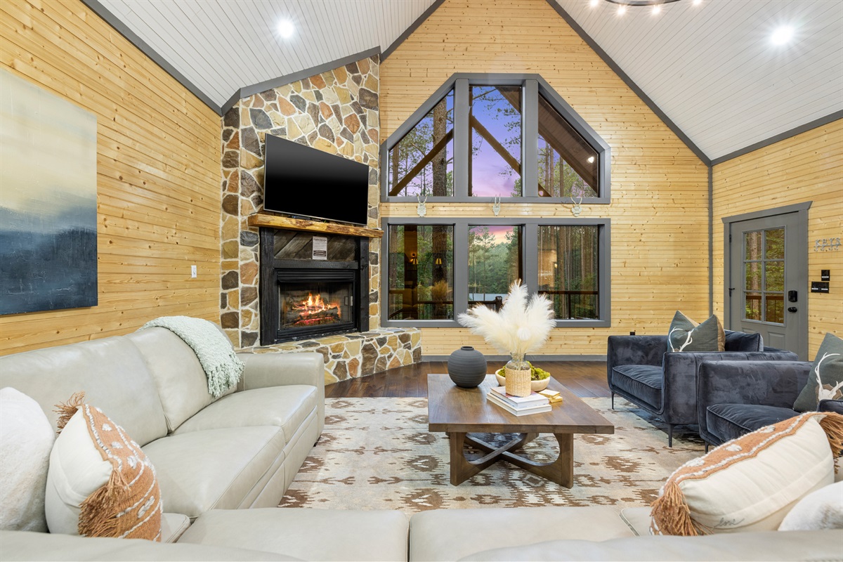 The inviting family room awaits your conversations, offers views, a large TV and a cozy fireplace!