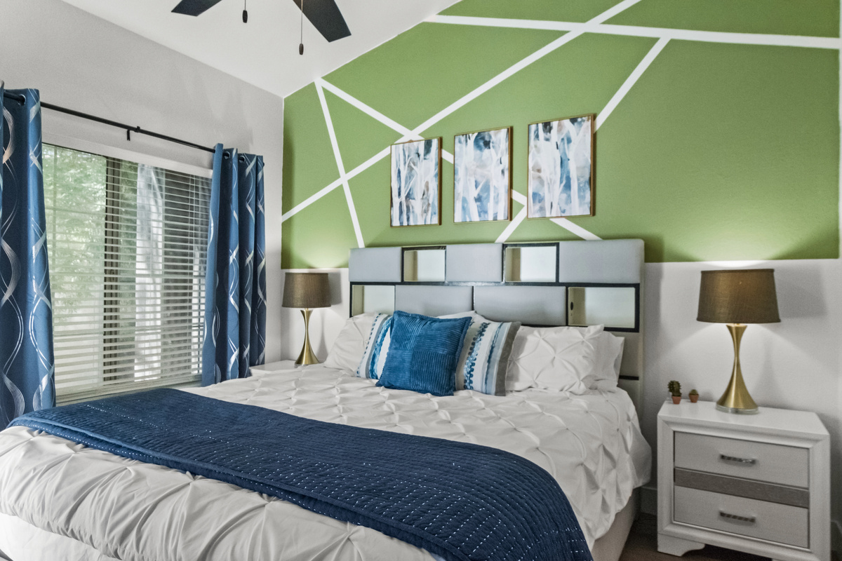 Another calming bed space for guests that features a Roku Smart TV, windows, and a comfortable hybrid mattress. 