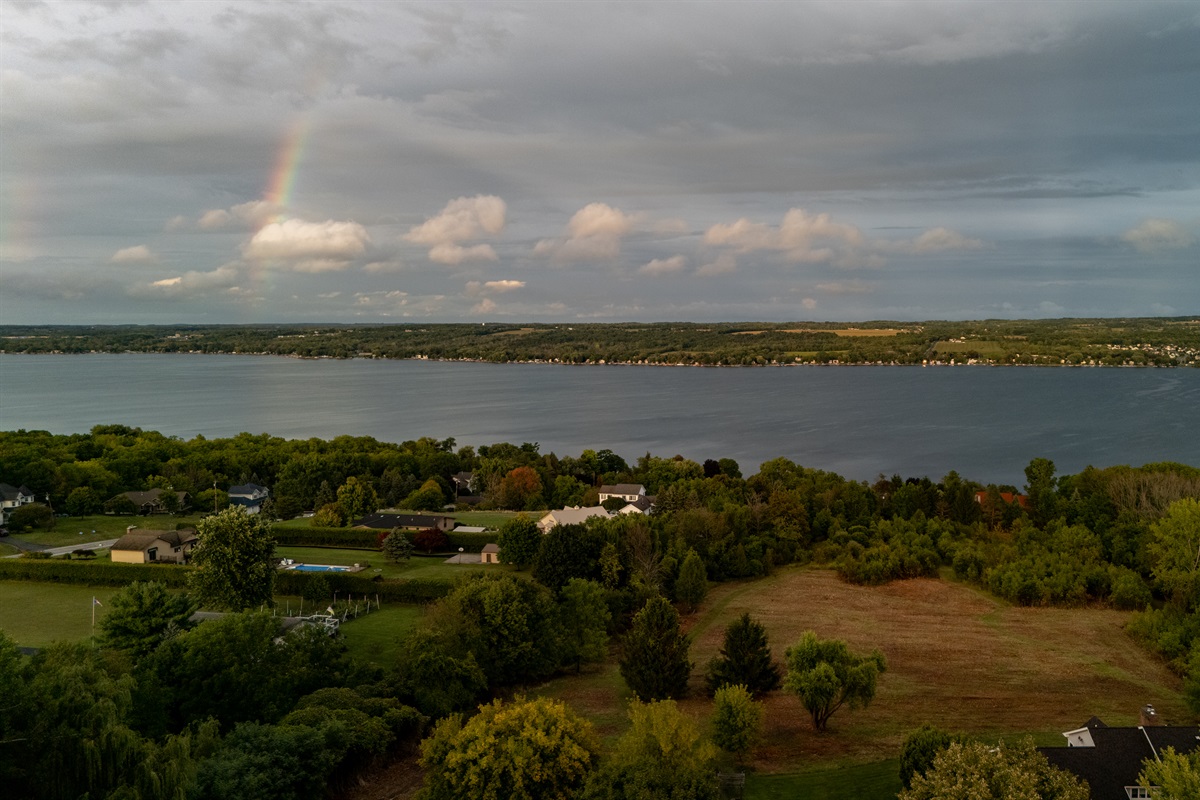 Breathtaking view of Canandaigua Lake with a vibrant rainbow stretching across the sky—nature’s beauty at its finest. Perfect for capturing the peaceful charm of the area.