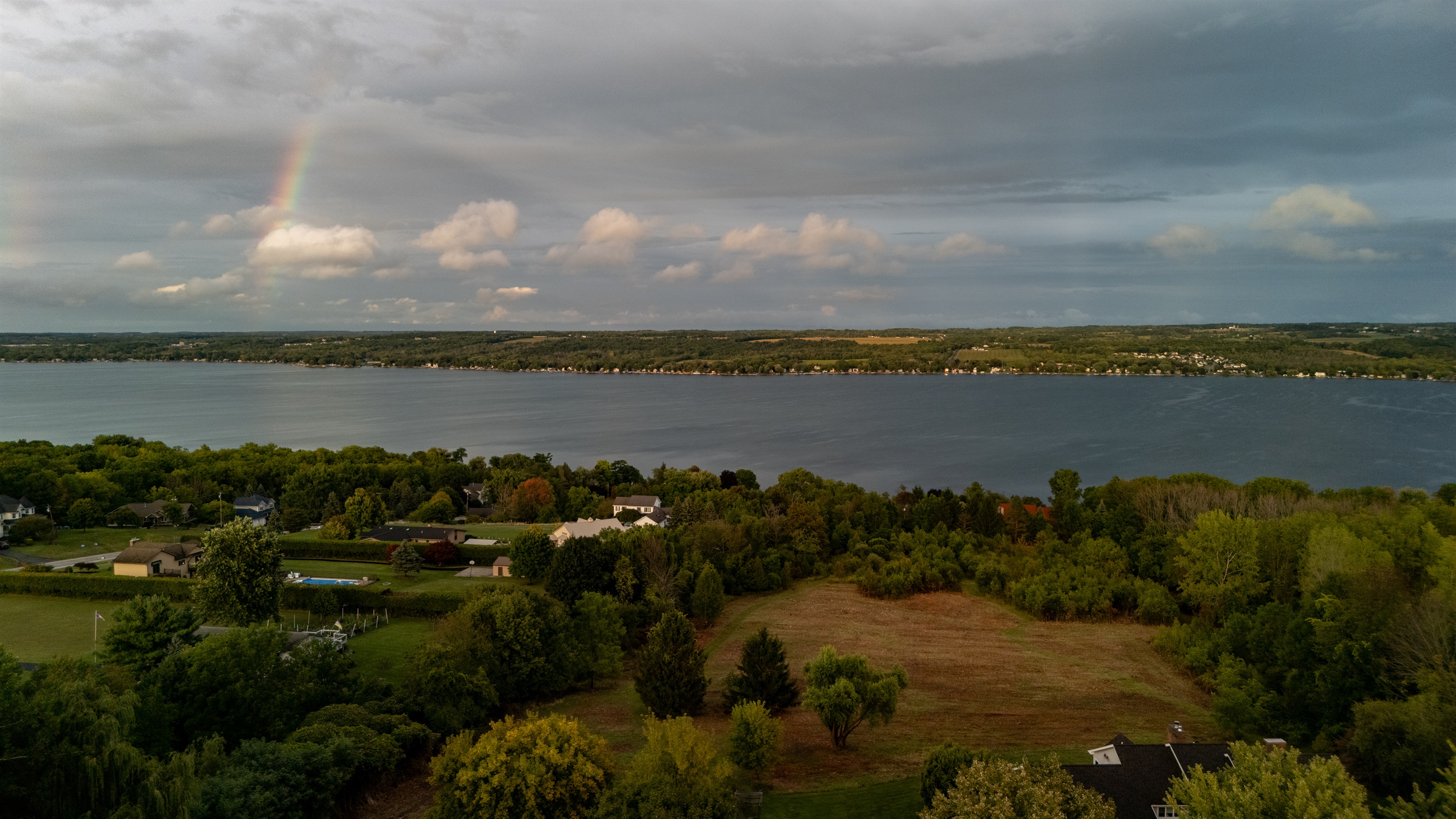 Breathtaking view of Canandaigua Lake with a vibrant rainbow stretching across the sky—nature’s beauty at its finest. Perfect for capturing the peaceful charm of the area.
