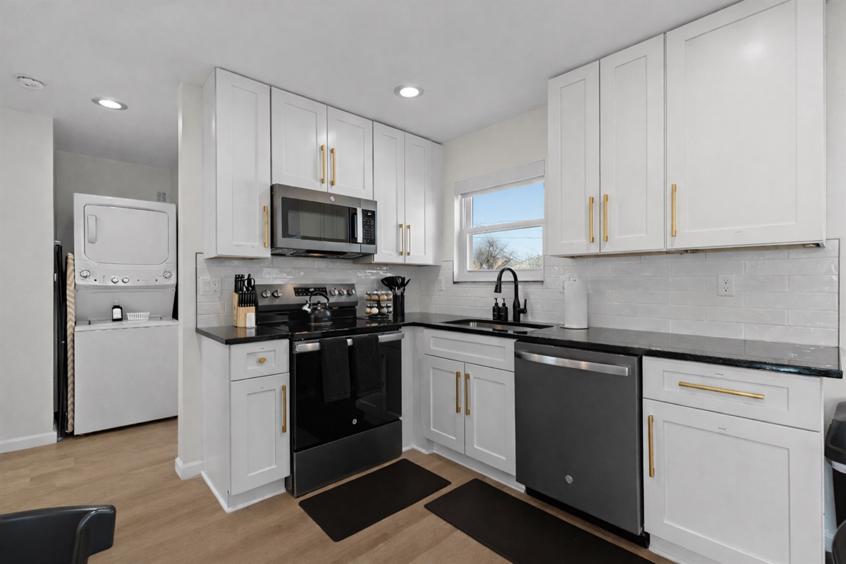 Bright, modern kitchen with full-size appliances, ample cabinet space, and sleek finishes—perfect for home cooking, meal prep, and longer stays.