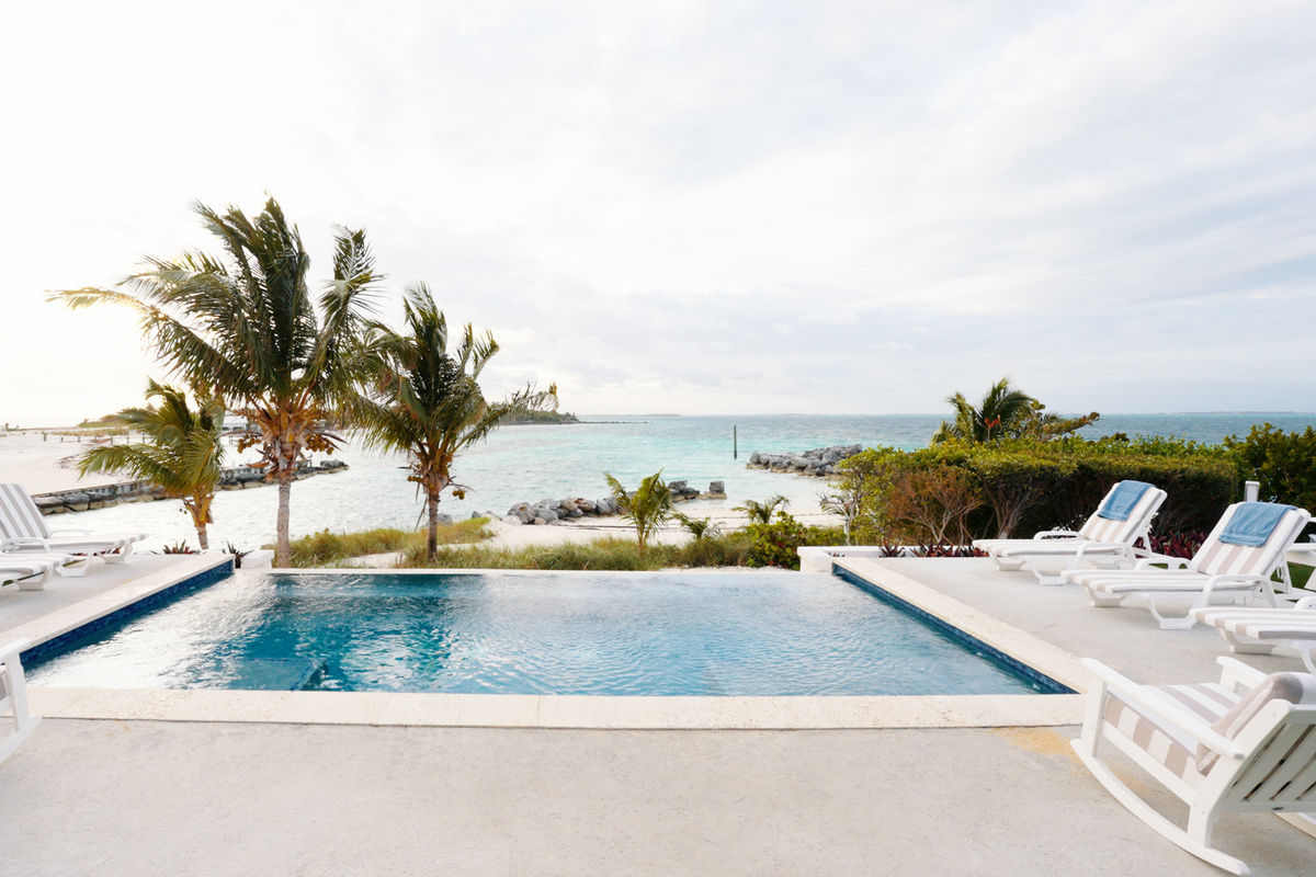 Heated Infinity Pool: Next to the Cabana overlooking the Sea of Abaco, surrounded by turf and manicured landscaping — the perfect place to lounge while the kids splash below.